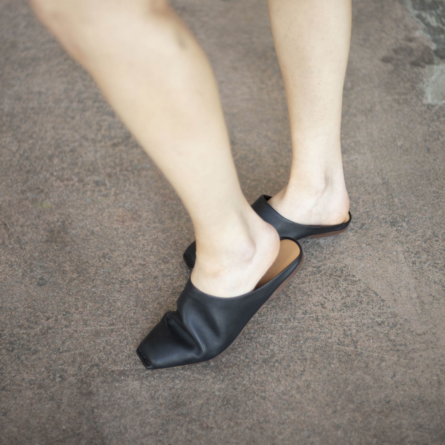 Try wearing slides of any shoe color o make your black outfit more classy